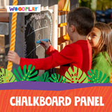 Children playing with a chalkboard panel in an outdoor setting, with Woodplay branding.