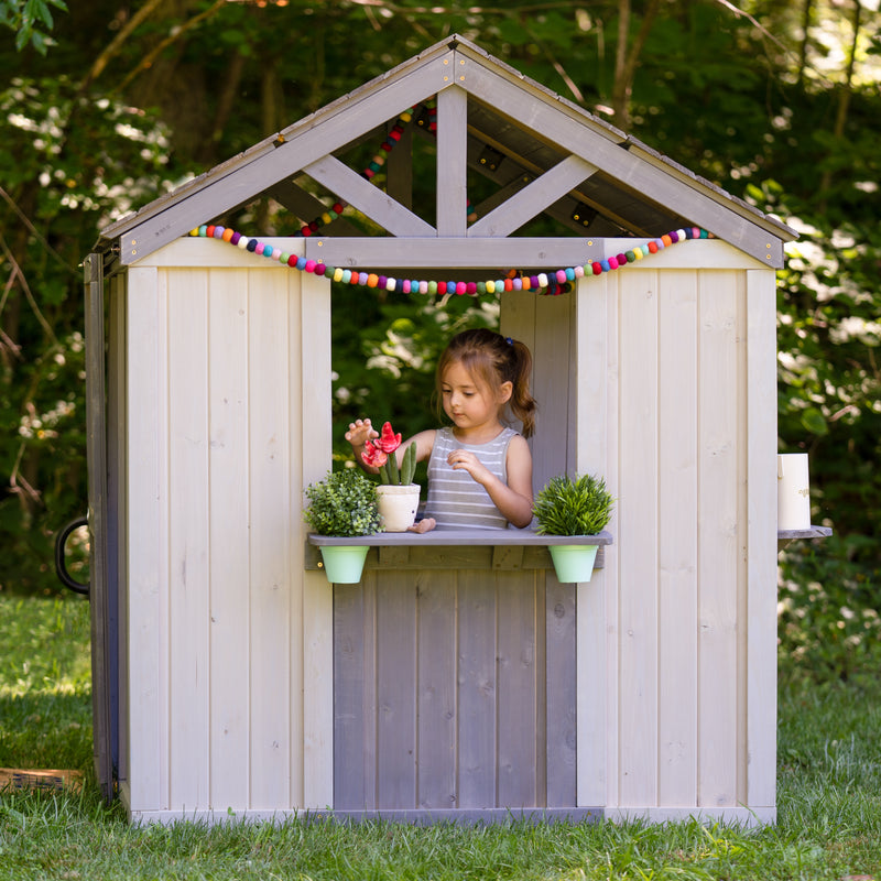 decorated wooden child's outdoor playhouse