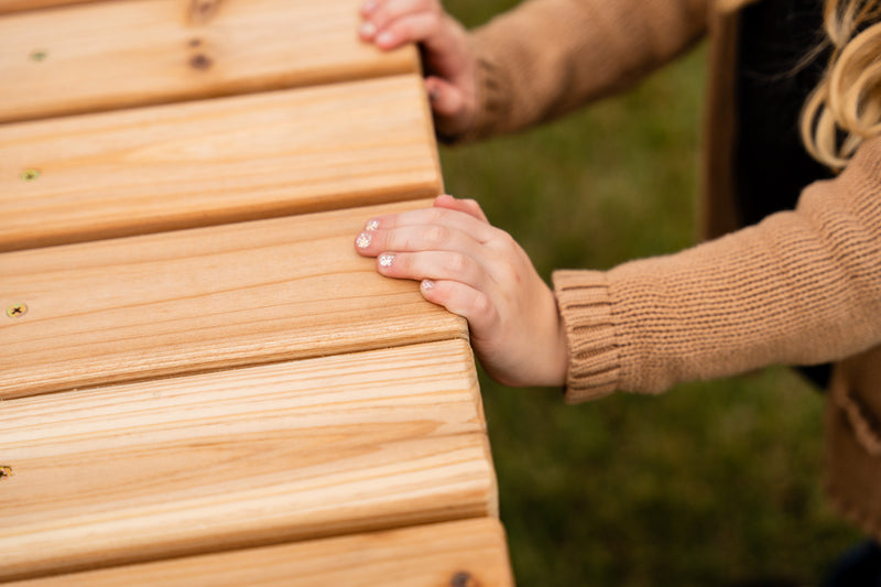 children's hands on picnic table